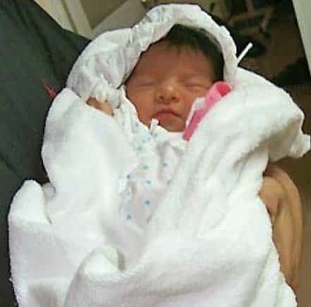 Baby Sharon swaddled in a white blanket