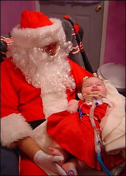 Madison Coulter being held by Santa Claus